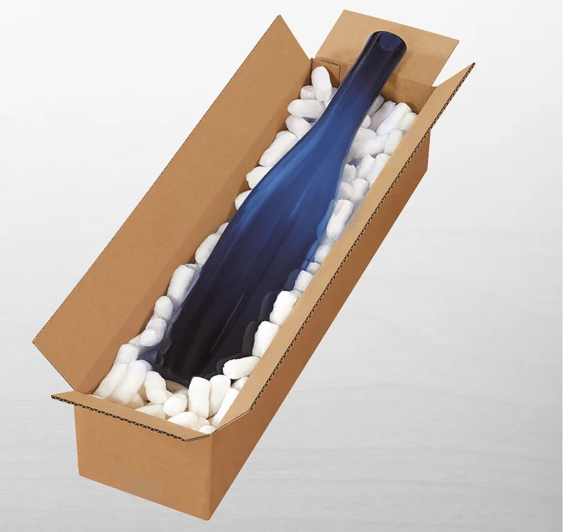 A long open corrugated box holding a bottle in packing peanuts