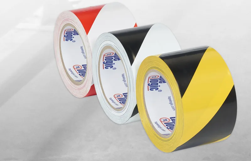 Striped vinyl safety tape in red and white, black and white, and black and yellow